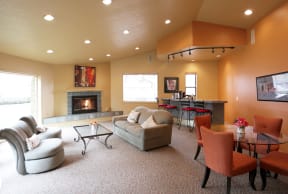 a living room with orange walls and a fireplace