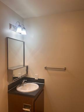A bathroom with a toilet, sink, and mirror.