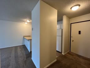 a bedroom with a medium sized desk and a refrigerator