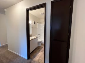 a bedroom with a medium sized bed and a mirror