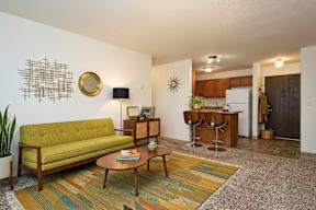 A living room with a green couch and a coffee table.
