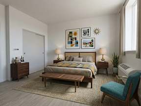 A bedroom with a bed, nightstands, and a chair.