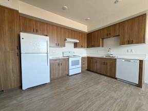 A kitchen with wooden cabinets and white appliances.