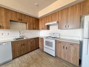 A kitchen with wooden cabinets and white appliances.