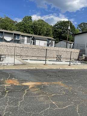 A fenced area with a building in the background.