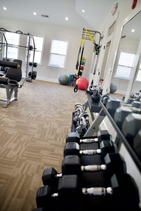 a spacious fitness center with treadmills and weights