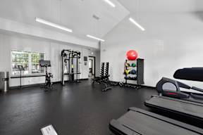 the gym with treadmills and weights at the belgard apartments