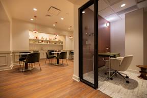 The community room at The Belle showcasing a mini office and a separate seating area.