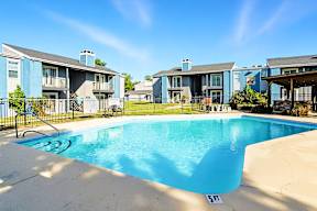 A swimming pool in front of apartment buildings.