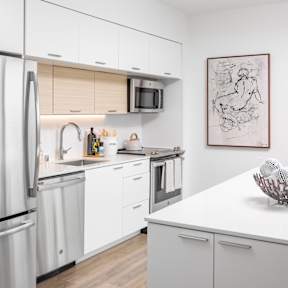 Kitchen with stainless steel appliances, granite countertops and island with storage