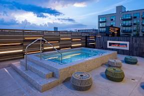 Year-round spa with fireplace at dusk