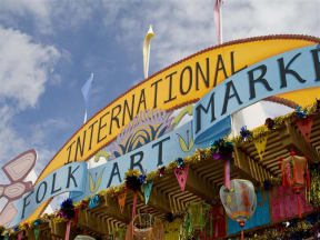 a fair with a sign that says international folk art market