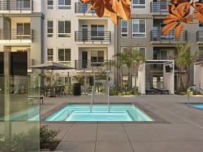 a swimming pool in front of an apartment building