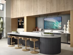 a modern kitchen with a large island and stools