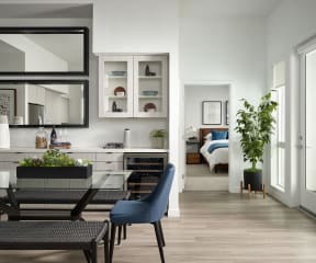 a living room and dining room with a table and chairs