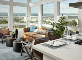 a living room with a couch and a table and chairs