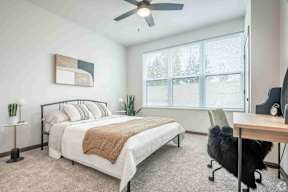 Large bedroom with window and carpet located at Deforest Yards in DeForest, WI