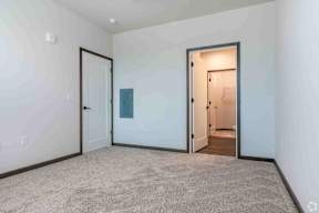 Large room with carpet and central cooling located at Deforest Yards apartments in DeForest, WI