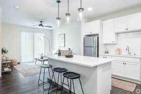 Modern kitchen with quartz counter tops and stainless steal appliances located at Deforest Yards apartments in DeForest, WI
