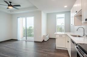 A kitchen with white cabinets and a black stove top oven located at Deforest Yards in DeForest, WI