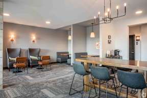 Lounge area with coffee bar and tables and chairs located at Deforest Yards in DeForest, WI