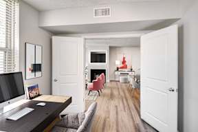 A room with a desk and chairs