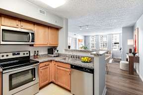 A kitchen with wooden cabinets and a dishwasher