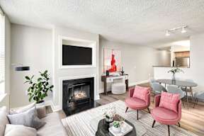 A living room with a fireplace, a TV, and chairs.
