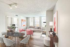 A living room with a table and chairs.