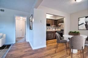 Modern kitchen with a dining table and chairs.