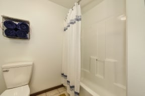 Bathroom with Tiled Floor, Toilet and White Curtains