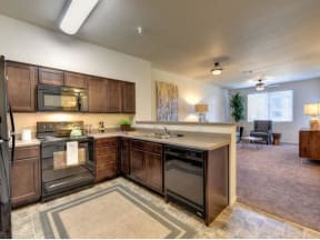 Chico Apartments - Kitchen With Wood-Like Flooring, All Electric Appliances, Dishwasher, Breakfast Bar, Refrigerator, Pantry, And Microwave