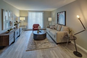 furnished living with wood-plank flooring