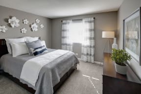 carpeted bedroom with furniture and window coverings