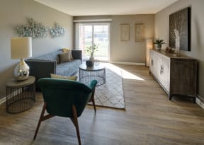 large living room with wood-plank flooring and natural lighting