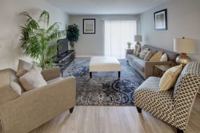 well-furnished living room with access to a patio