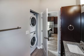 a bathroom with a washer and dryer  at RoCo Apartments, Fargo, 58102