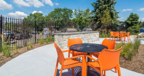 BBQ grills and an outdoor dining area at Axis at Westmont Apartments