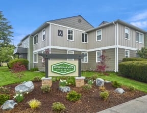 Exterior view of building and front sign with well maintained landscaping. at Woodhaven, Everett, WA