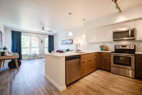 Kitchen with Wood Inspired Floor, Oven, Stove, at Avaya Ridge Apartments, Renton, WA, 98055