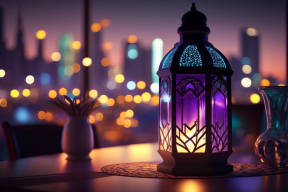 a lantern on a table with a city skyline in the background