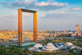 an aerial view of a city with a tall tower in the middle