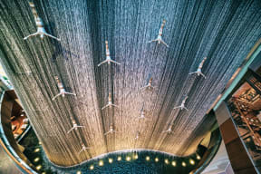 a group of airplanes hanging from the ceiling of a mall