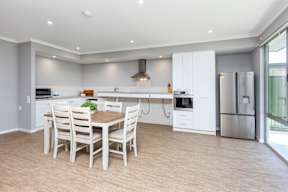 A modern kitchen with a dining table and chairs.