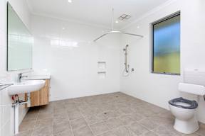 A bathroom with a toilet, sink, and shower.