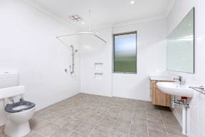 A bathroom with a toilet, sink, and shower.