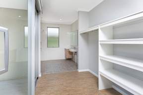 A room with a white shelving unit and a glass door.