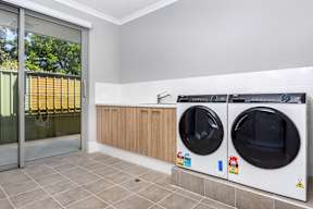 A laundry room with a washer and dryer.