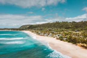 A beautiful beach with clear blue water and white sand.