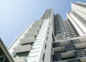 a tall white building with a blue sky in the background
